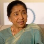 Legendary playback singer Asha Bhosle in traditional saree, smiling warmly