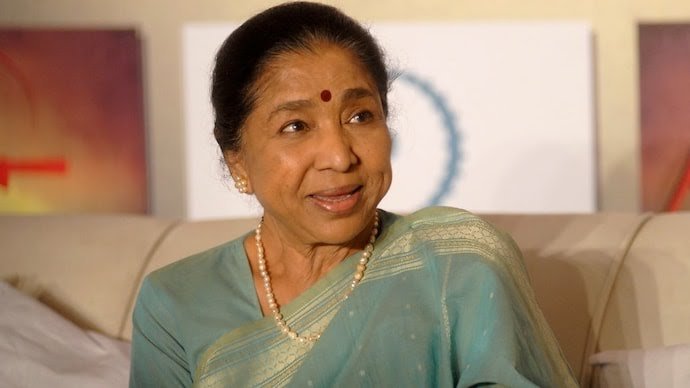 Legendary playback singer Asha Bhosle in traditional saree, smiling warmly