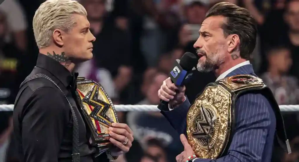 Cody Rhodes and Randy Orton holding WWE championship belts during a tense SmackDown segment.
