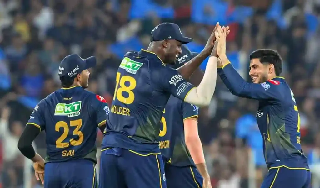 Jason Holder and Gujarat Titans teammates celebrating a wicket during IPL 2026 match against RCB.