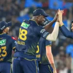 Jason Holder and Gujarat Titans teammates celebrating a wicket during IPL 2026 match against RCB.