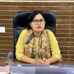 Kajal Meena seated at her office desk in a government office.