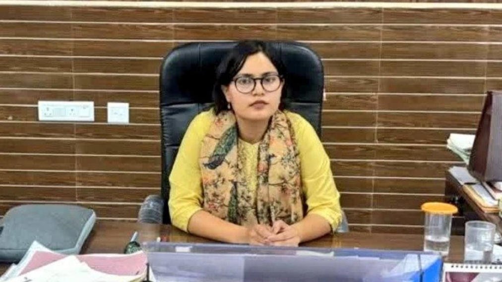 Kajal Meena seated at her office desk in a government office.
