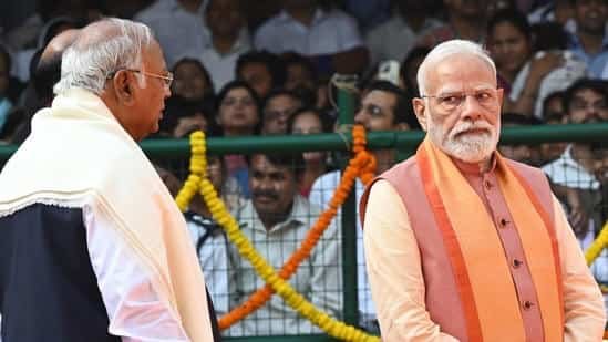 Alt Text: Prime Minister Narendra Modi and Congress president Mallikarjun Kharge at a public political event.