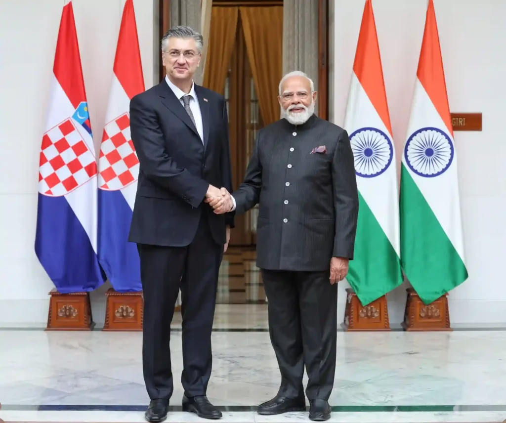 Narendra Modi shaking hands with Croatian Prime Minister Andrej Plenković in front of Indian and Croatian flags