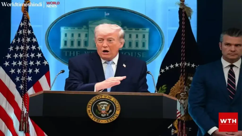 Donald Trump stands at a White House podium during a press briefing, with the presidential seal and flags visible behind him.