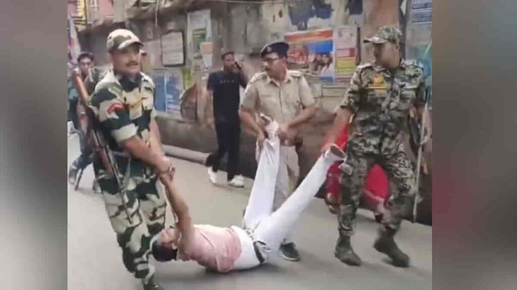 CRPF personnel detaining a man after a clash over an EVM glitch at a Howrah polling booth during the West Bengal assembly elections.