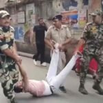 CRPF personnel detaining a man after a clash over an EVM glitch at a Howrah polling booth during the West Bengal assembly elections.