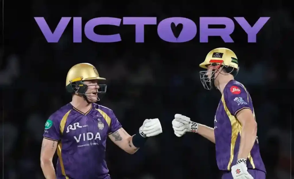 Two Kolkata Knight Riders players celebrate after a win with a fist bump.