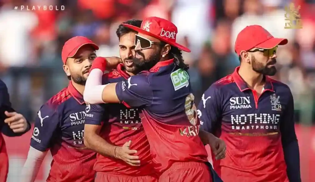 RCB players celebrating together on the field after the match.