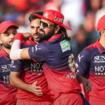 RCB players celebrating together on the field after the match.
