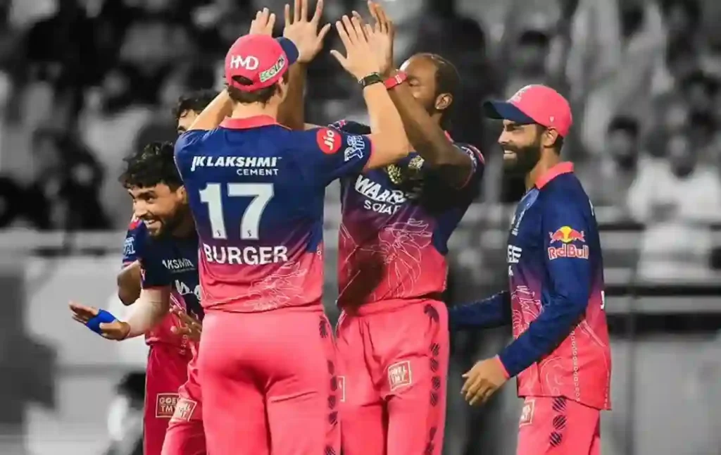 Rajasthan Royals players stand together celebrating after an important play.
