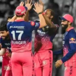 Rajasthan Royals players stand together celebrating after an important play.