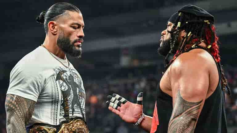 Roman Reigns and Jacob Fatu standing face to face during a tense WWE raw segment.