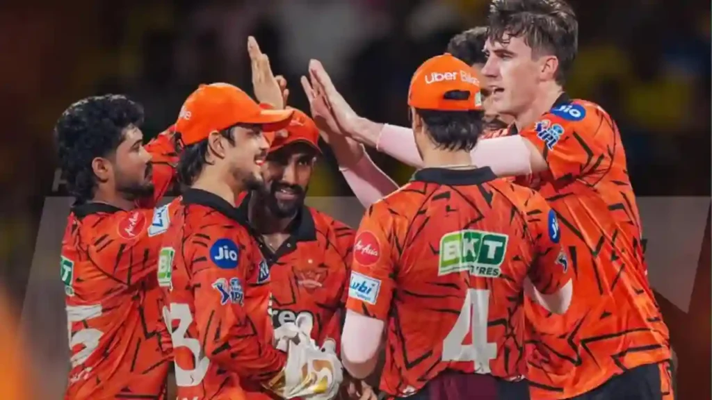 SRH players celebrating together after a match in orange jerseys.