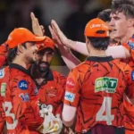 SRH players celebrating together after a match in orange jerseys.