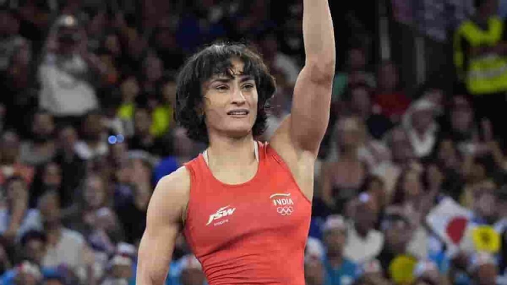 Vinesh Phogat raises her arm after a match at the Paris Olympics.