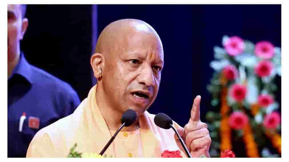 Yogi Adityanath speaking at a podium during a public event.