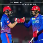 Two Delhi Capitals players fist-bumping on the cricket pitch with an overlay text reading "DC WIN BY 3 WICKETS".