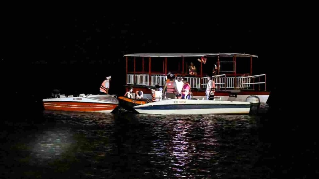 Rescue teams conducting search operations for missing passengers after a cruise boat capsized in Bargi Dam, Jabalpur.