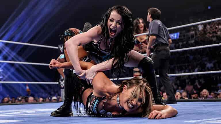 Brie Bella and Paige celebrate after defeating Fallon Henley and Lainey Reid in a tag team match.